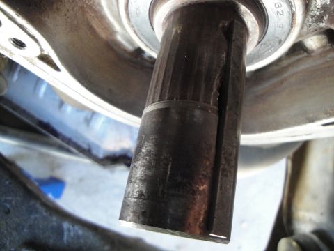 1995 Ford Taurus - A close-up view reveals a damaged metal shaft with a significant split and signs of wear.