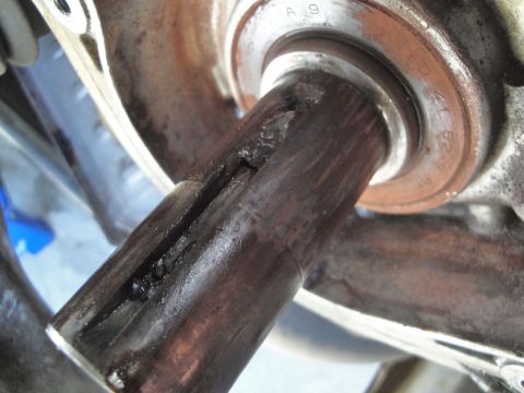 1995 Ford Taurus - The axle shaft shows significant damage, including a split and debris, indicating a need for replacement.