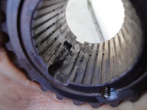 1995 Ford Taurus - This image shows a close-up view of a worn metal part, likely a component from a vehicle's drivetrain, exhibiting internal splines and a th…
