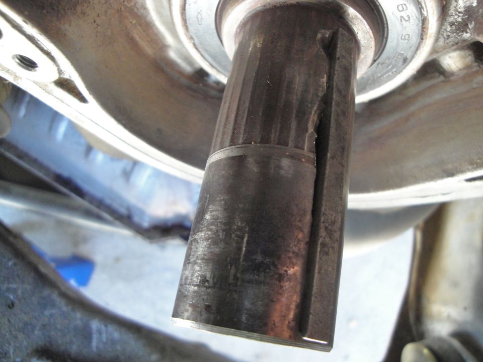 Close-up of a metal shaft with a crack and splines