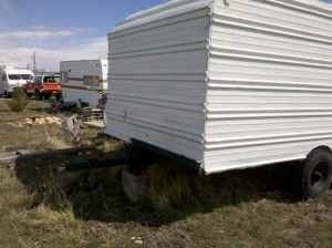 2006 Ford E350 - Several trailers and a pickup truck are visible in an outdoor storage area.