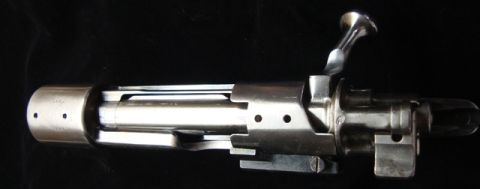 1991 Ford Bronco - Close-up view of a bolt action rifle mechanism, its intricate metal components and polished surface.