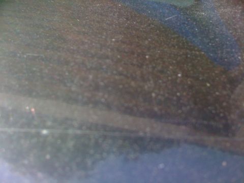 1985 Ford Mustang - Close-up of a dusty surface with a blue stripe, possibly a car's interior or exterior.