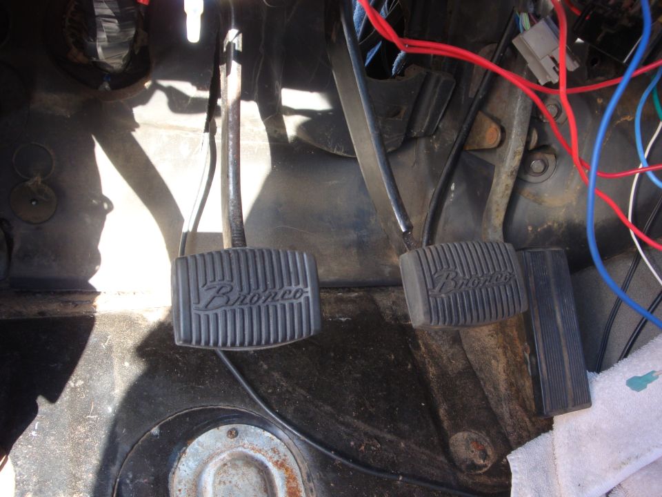 1989 Ford Bronco interior footwell showing brake and clutch pedals with 'Bronco' branding