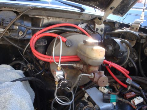 1989 Ford Bronco - Close-up view of engine bay components, including brake booster and master cylinder.