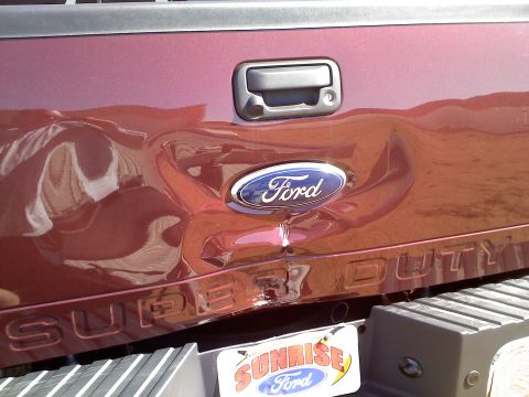 2011 Ford F-250 - This Ford Super Duty tailgate has sustained significant damage, affecting the emblem and body panel.