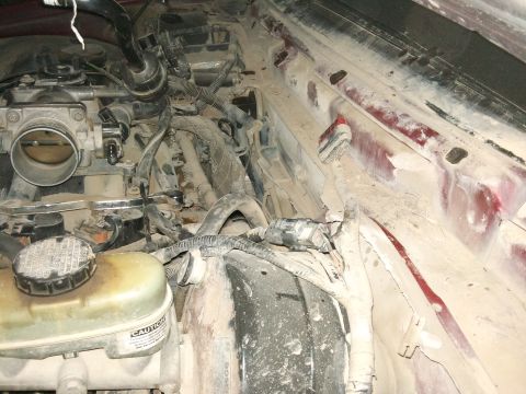 1998 Ford Crown Victoria - Dust-covered engine bay components, including a throttle body and brake fluid reservoir, are visible.