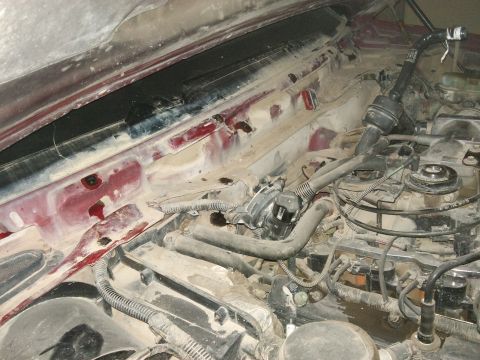 1998 Ford Crown Victoria - The dusty engine bay and wiper tray area are visible in this close-up shot.