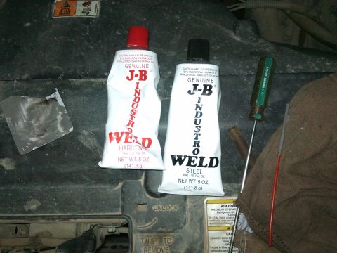 1998 Ford Crown Victoria - J-B Weld products are shown with a screwdriver and rags, likely for a repair job.