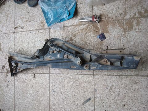 1998 Ford Crown Victoria - A disassembled wiper tray assembly is shown on a tiled surface, with tools nearby.