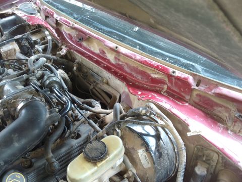 1998 Ford Crown Victoria - Engine bay view of a 1998 Ford Crown Victoria, showing the brake booster and various engine components.