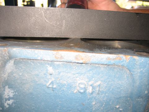 1998 Ford Crown Victoria - Side of a blue engine block with cast number markings reading 4 and 811 below a straightedge laid across the deck.