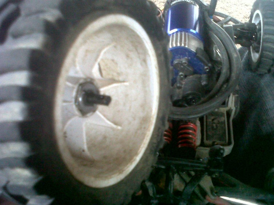 Close-up of a remote control car wheel and suspension components