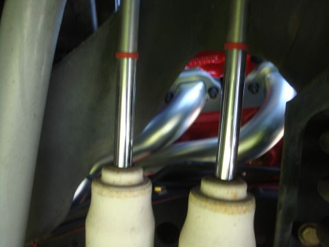 1989 Ford Bronco - Close-up view of engine exhaust manifold and shock absorbers.