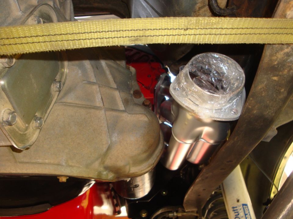 Exhaust manifold and transmission housing with a yellow strap overhead