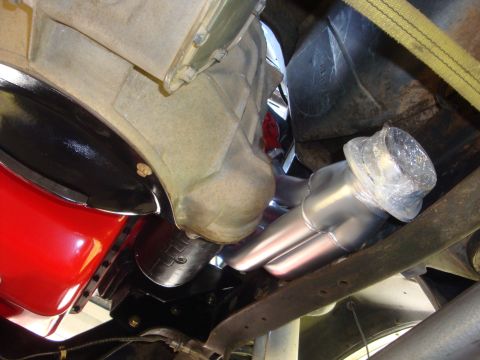 1989 Ford Bronco - Underside view of a vehicle's engine compartment, focusing on the exhaust manifold and transmission assembly.