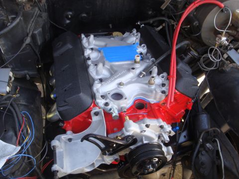 1989 Ford Bronco - Engine bay view of a rebuilt engine red valve covers and intake manifold, with red spark plug wires visible.
