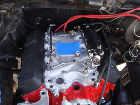 1989 Ford Bronco - Engine bay detail showing fuel system components, including a fuel pressure regulator with a gauge.