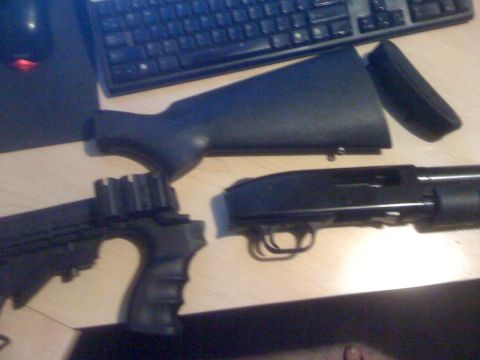 1991 Nissan Pathfinder - A disassembled black shotgun lies on a desk next to a computer keyboard.