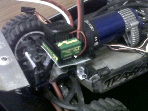 2011 Ford 427 - This image shows the motor and electronic speed controller of a remote control car, with visible branding from 'Castle' and 'Traxxas'.