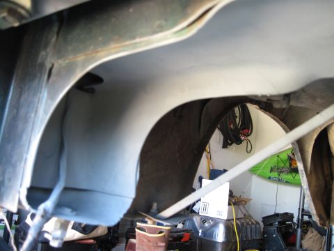1979 Ford Bronco - A close-up view of the undercarriage reveals the vehicle's internal structure and a fuel tank.