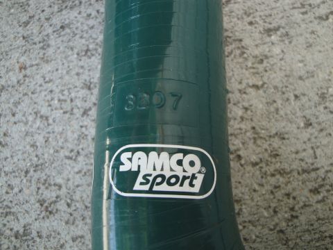 1995 Ford Taurus - A close-up of a green silicone hose, the SAMCO Sport logo and embossed part number.