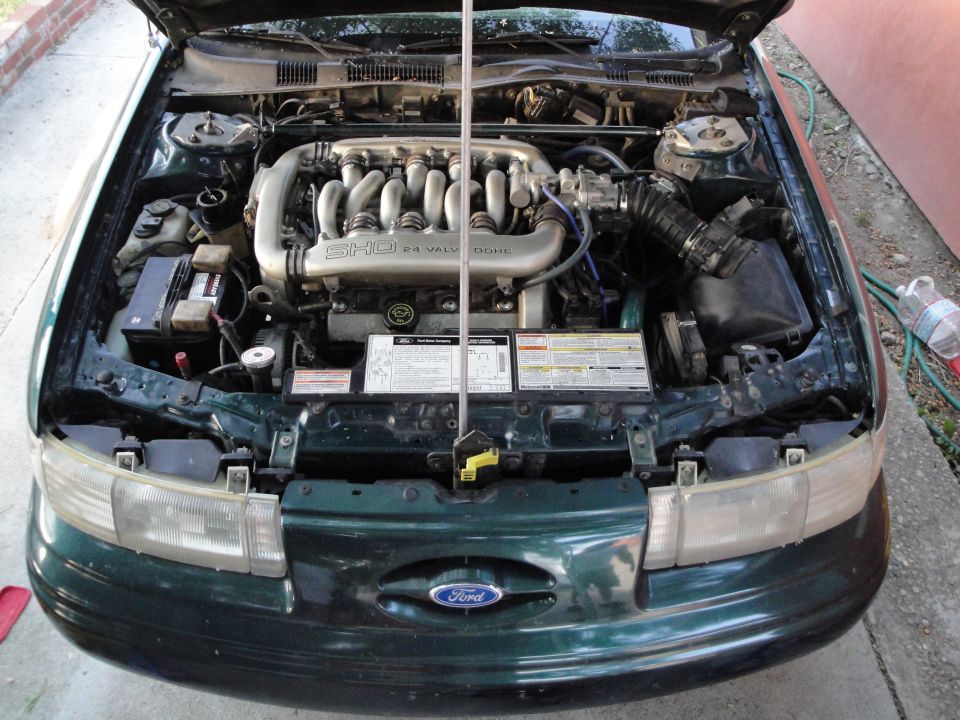 Green 1995 Ford Taurus engine bay with SHO 3.0L V6 engine visible