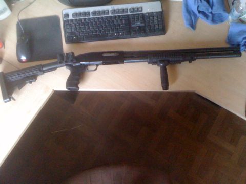 1991 Nissan Pathfinder - A tactical shotgun is laid out on a desk with computer peripherals.