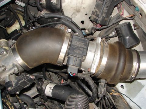 1992 Ford Taurus - Close-up view of an engine's air intake system, including the mass airflow sensor.