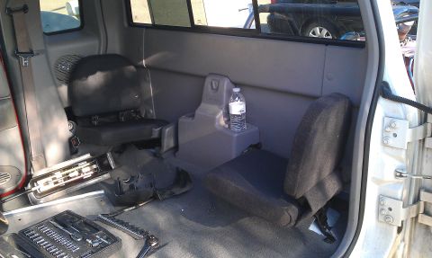 1992 Ford Ranger - The interior of a pickup truck shows two small seats and tools on the floor.