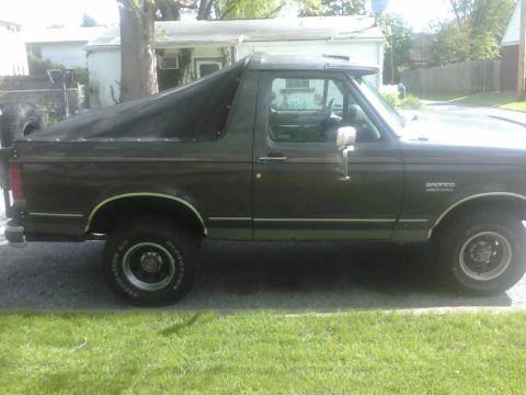 1988 Ford Bronco - This 1988 Ford Bronco is shown from the side, a soft top over its rear cargo area.
