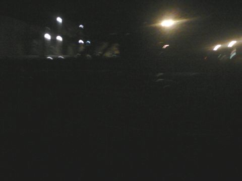 1988 Ford Bronco - A dark scene with blurred lights, possibly from a vehicle's headlights or streetlights.