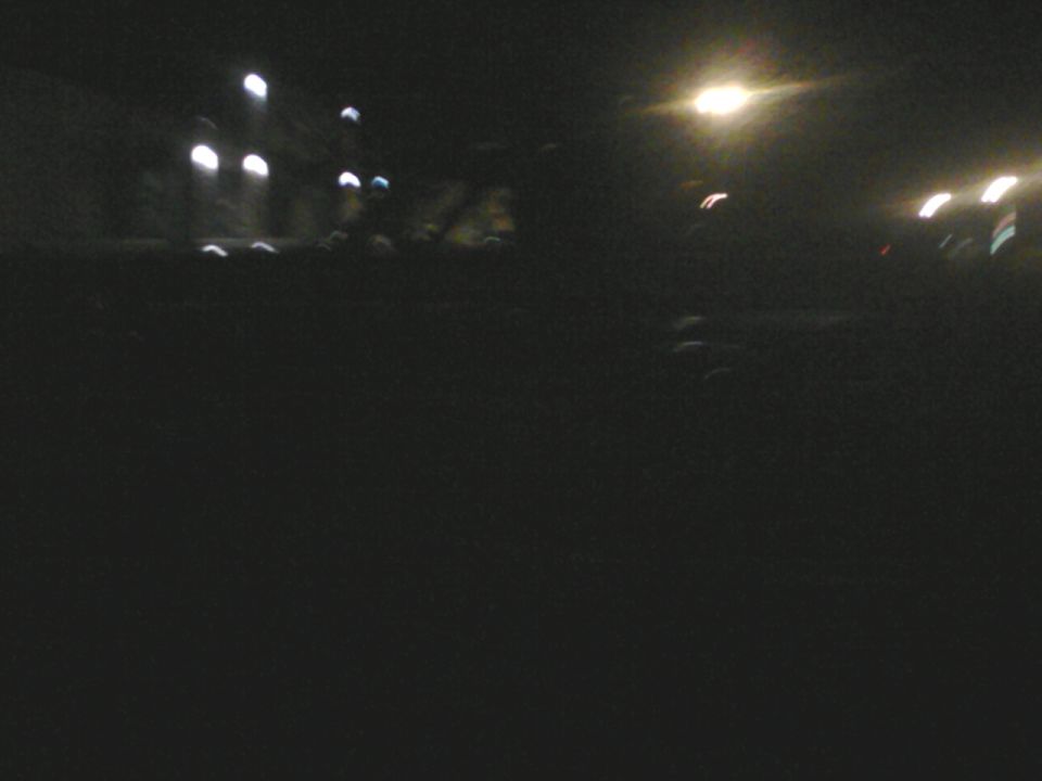 Dark scene with blurred lights and a watermark
