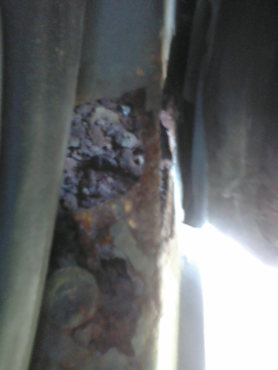 rusted frame rail with some debris