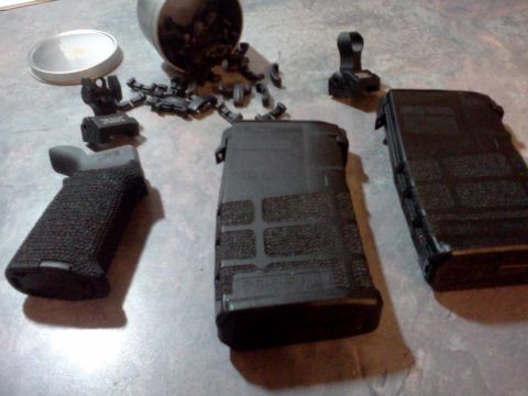 1996 Ford Bronco - Various firearm components, including a textured grip and two magazines, are laid out on a surface.