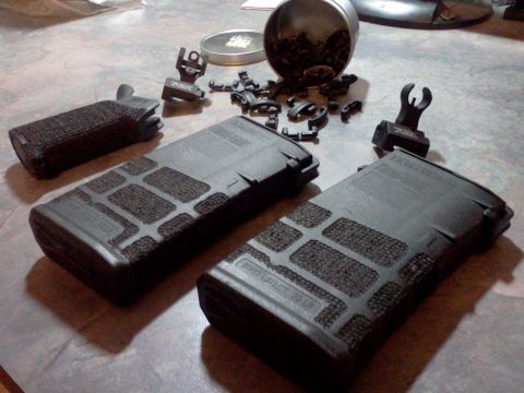 1996 Ford Bronco - Various firearm accessories, including magazines and sights, are arranged on a flat surface.