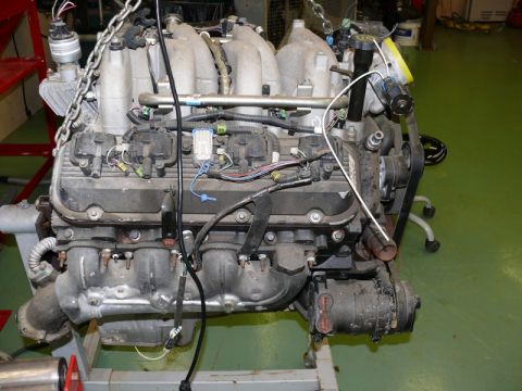 1976 Chevrolet Corvette - This V8 engine is suspended by a chain and appears to be undergoing maintenance or preparation for installation.