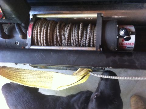 1990 Ford Bronco - A winch is shown with an engaged label and a tow strap attached to its cable.