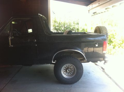 1990 Ford Bronco - Black 1990 Ford Bronco with removable top, seen from the side.