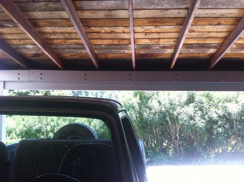 1990 Ford Bronco - Interior view of a vehicle with a spare tire and a wooden ceiling.