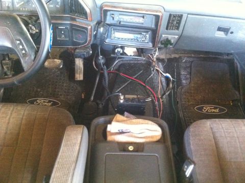 1990 Ford Bronco - The interior of a 1990 Ford Bronco features a CB radio and aftermarket stereo system.