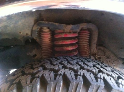 1990 Ford Bronco - The image shows the suspension system, including springs and a tire, of a vehicle.