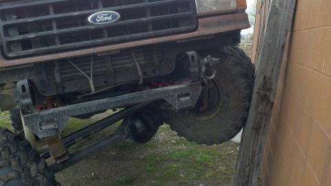 1988 Ford Bronco - Front view of a 1988 Ford Bronco with modified suspension and large tires.
