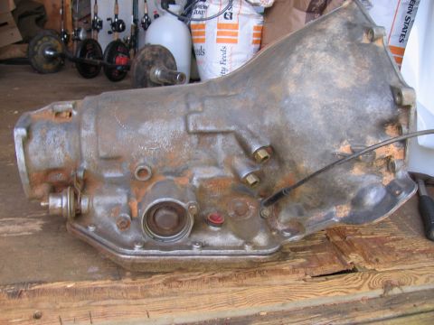 1980 Jeep CJ7 - A rusty automatic transmission is shown resting on a weathered wooden surface.