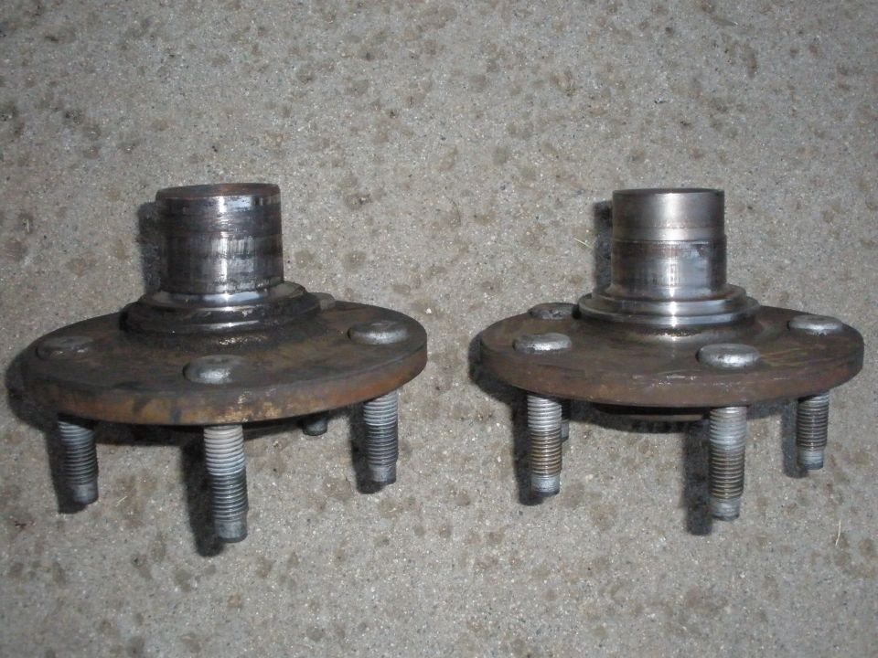 Two front wheel hubs with five lug bolts each