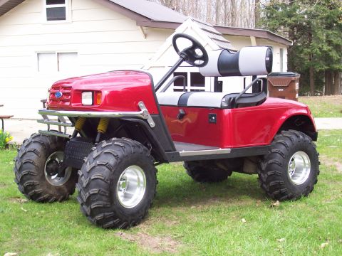 1978 Ford F-150 - This modified golf cart features a Ford emblem and aggressive tires, suggesting a custom build rather than a stock vehicle.
