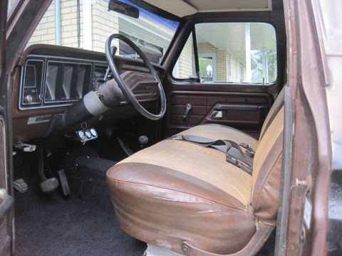 1979 Ford Bronco - The interior of this 1979 Ford Bronco features a brown dashboard and two-tone brown and tan seats.
