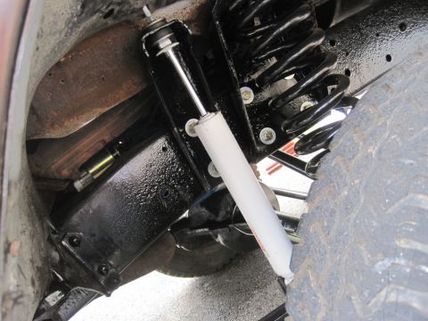 1979 Ford Bronco - Vehicle suspension components including a shock absorber and coil spring are visible.