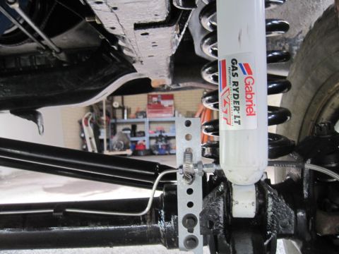 1979 Ford Bronco - The underside of a vehicle shows suspension components, including a Gabriel shock absorber and springs.