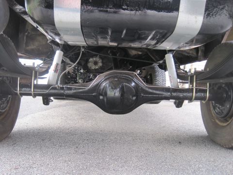 1979 Ford Bronco - Undercarriage view of a 1979 Ford Bronco, showing the rear axle and suspension components.